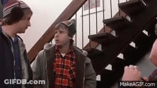 Three Men Are Standing Next To Each Other On A Set Of Stairs Talking To Each Other . GIF