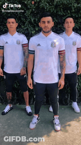 Three Men Are Standing Next To Each Other Wearing White Adidas Shirts And Shorts GIF