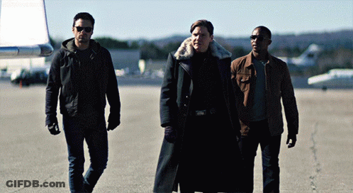 Three Men Are Walking On A Runway And One Has A Fur Collar GIF