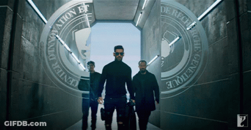 Three Men Are Walking Through A Tunnel That Says Innovation Et De Recevoir GIF