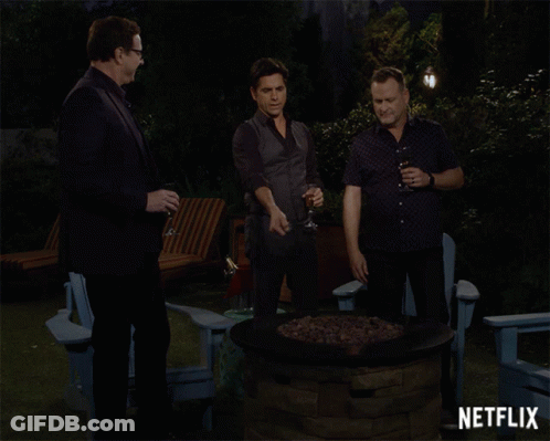 Three Men Around Fire Pit With Netflix GIF