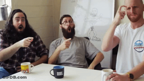 Three Men Around Table One Wearing The Bay Shirt GIF