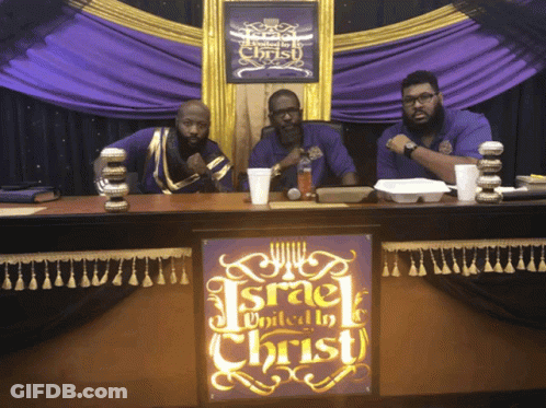 Three Men At Table With Israel United To Christ Sign GIF