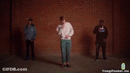 Three Men Dancing In Front Of Brick Wall GIF