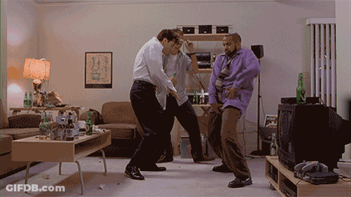 Three Men Dancing In Living Room With Egyptian Poster GIF