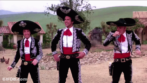 Three Men Dressed In Mariachi Outfits Are Dancing GIF