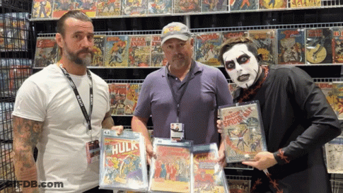 Three Men Holding Comic Books GIF