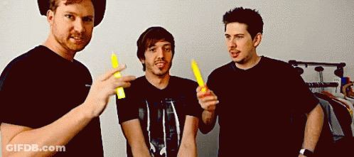 Three Men Holding Yellow Sticks GIF