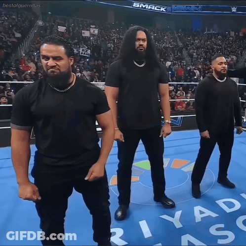 Three Men In Black Shirts On Wrestling Ring With Riyad GIF