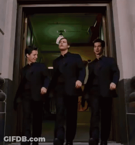 Three Men In Black Suits Are Walking Out Of A Doorway GIF