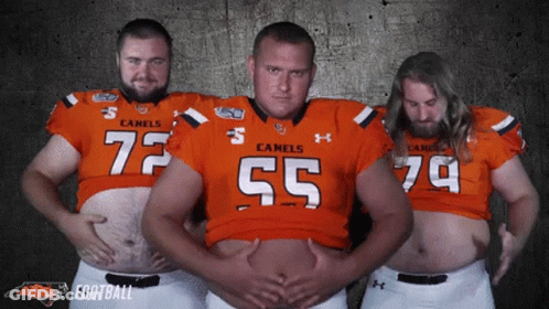 Three Men In Camels Football Jerseys Posing GIF