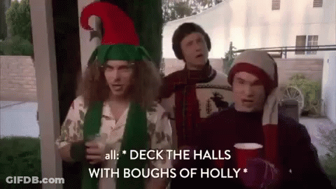 Three Men In Christmas Costumes On Porch GIF