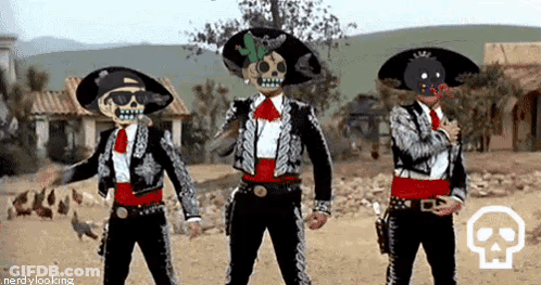 Three Men In Day Of The Dead Costume Are Dancing In A Desert . GIF