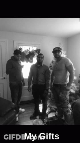 Three Men In Front Of Christmas Tree Saying My Gifts GIF