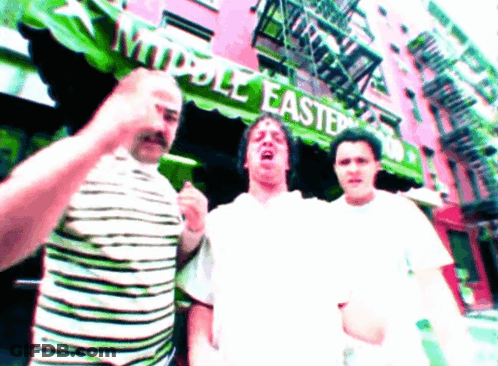 Three Men In Front Of Green Awning Saying Middle East GIF