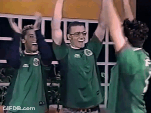 Three Men In Green Shirts Number 2 Raising Arms GIF