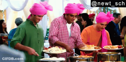 Three Men In Pink Turbans Serving Buffet Food GIF