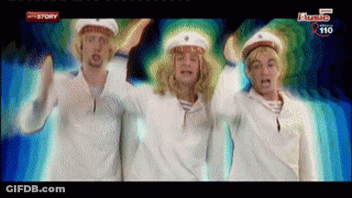 Three Men In Sailor Hats Are Dancing In Front Of A Screen That Says ' History ' On It GIF