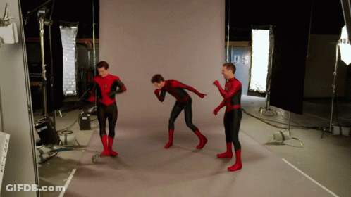 Three Men In Spider Man Costumes Are Standing In A Room GIF