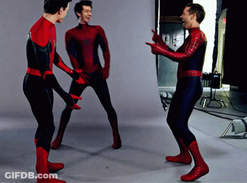 Three Men In Spiderman Costumes Are Standing In A Room GIF