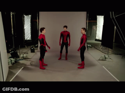 Three Men In Spiderman Costumes Are Standing In Front Of A White Wall GIF