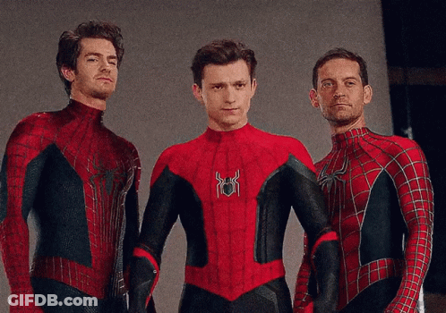 Three Men In Spiderman Costumes Pose For A Photo GIF