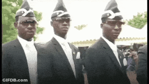 Three Men In Suits And Coffin Hats Are Standing Next To Each Other GIF