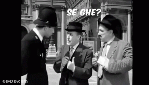 Three Men In Suits And Hats Are Standing Next To Each Other On A Street Talking To Each Other . GIF