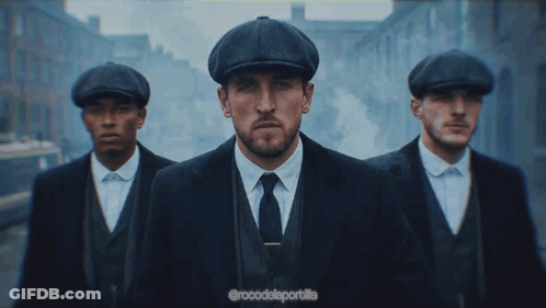 Three Men In Suits And Hats Are Walking Down A Street With The Caption @Rocodelaportalla GIF
