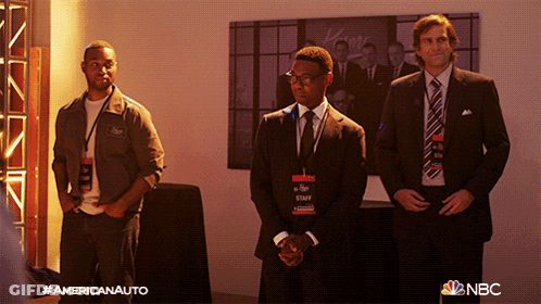Three Men In Suits And Ties Are Standing In Front Of A Wall With A Nbc Logo GIF