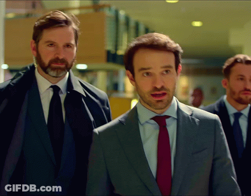 Three Men In Suits Walking Together GIF