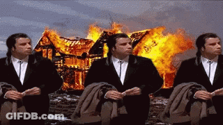 Three Men In Suits Are Sitting In Front Of A Burning House . GIF