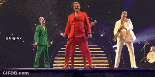 Three Men In Suits Are Standing On A Stage . GIF