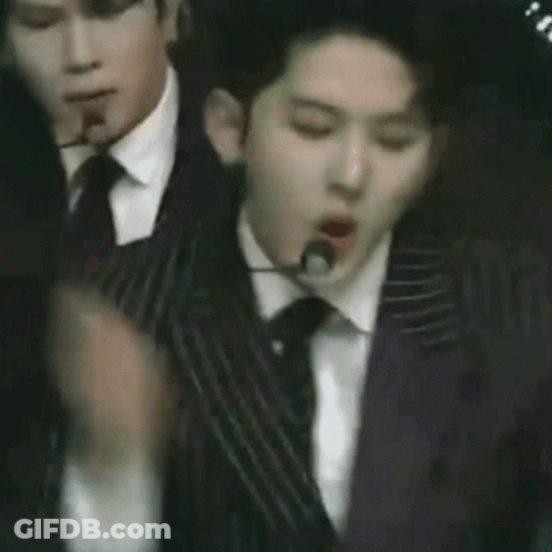 Three Men In Suits Dancing On Stage GIF