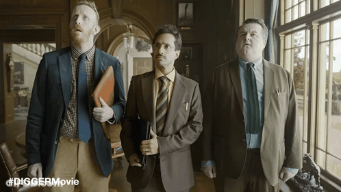 Three Men In Suits In Front Of Window With Diggermovie GIF
