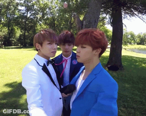 Three Men In Suits Standing In Park GIF