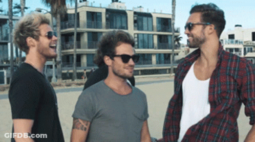 Three Men In Sunglasses Laughing On Beach GIF