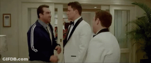 Three Men In Tuxedos Shaking Hands GIF