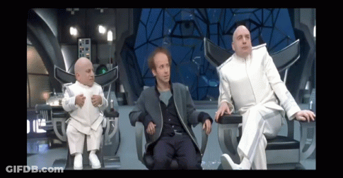 Three Men In White Suits Are Sitting In Chairs In A Futuristic Room GIF