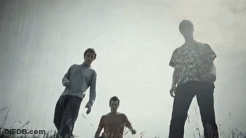 Three Men Looking Up In Field GIF