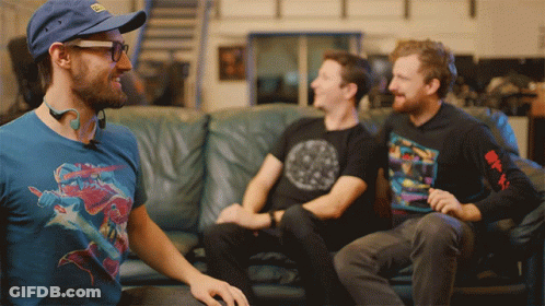 Three Men On Couch One Wearing Avengers Shirt GIF