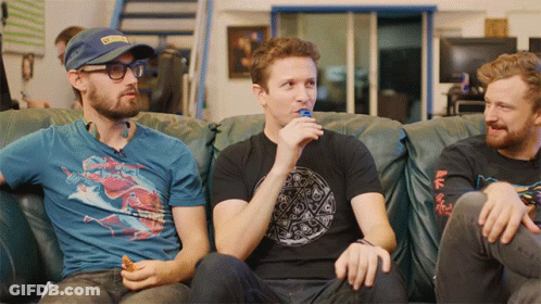 Three Men On Couch One Wearing Blue Shirt SDG GIF