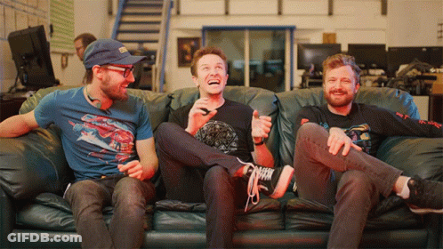Three Men On Couch One Wearing Spiderman Shirt GIF