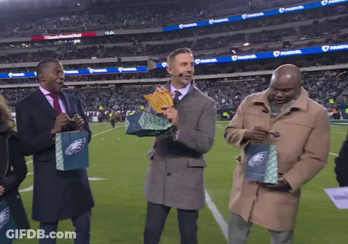 Three Men On Football Field Holding Eagles Bags GIF