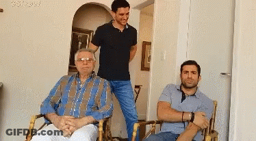 Three Men Posing One Wearing Glasses GIF