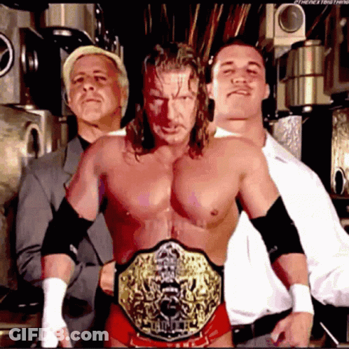 Three Men Posing With Championship Belt GIF