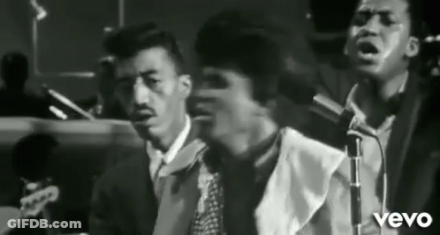 Three Men Singing Into Microphones In Band GIF