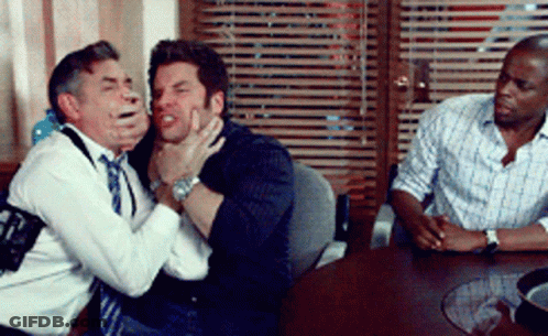 Three Men Sitting Around Table Holding Face GIF