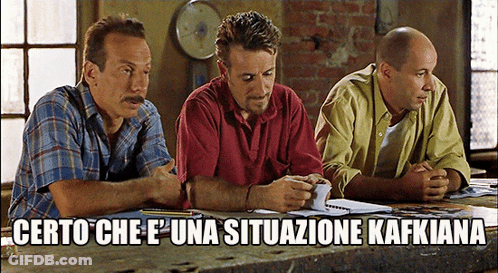 Three Men Sitting At Table Saying Certo Che E ' Una Situazione Kafkiana GIF