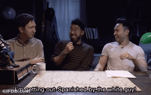 Three Men Sitting At Table With Mug I'm Getting Out-Spanish By The White Guy GIF